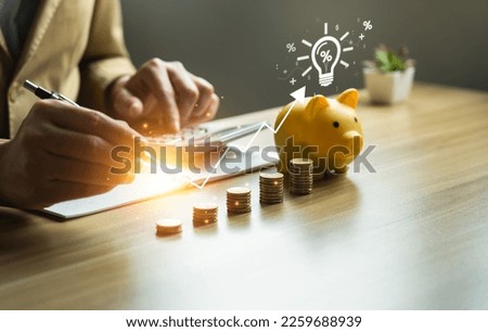 interest rates and dividends, investment returns, income, retirement Compensation fund, investment, dividend tax. Piggy bank and pile of coins and the plus percent symbol. saving money for investment Royalty-Free Stock Photo #2259688939