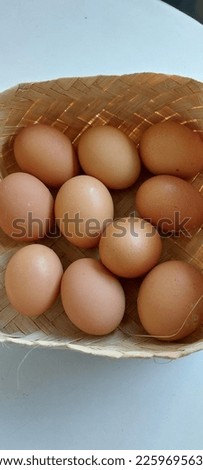 Chicken eggs in a woven bamboo container, picture taken using the high angle technique.