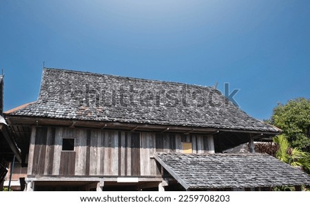 Roof of asian house in norther part of Thailand covered with old and tiny teak planks in vintage styles, soft focus.