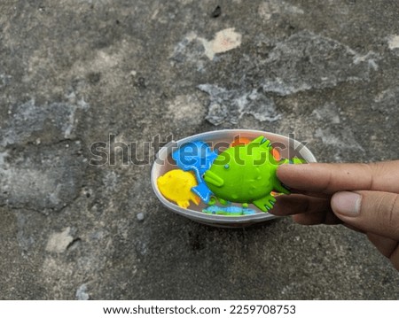 Toy fish over abstract background with water splashes