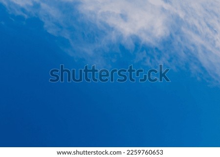 Summer cloudy blue sky background. Panoramic view with beautiful clouds. Horizontal cloudscape. Design element. Copy space.