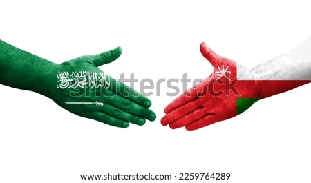 Handshake between Oman and Saudi Arabia flags painted on hands, isolated transparent image.