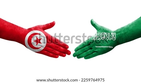 Handshake between Saudi Arabia and Tunisia flags painted on hands, isolated transparent image.