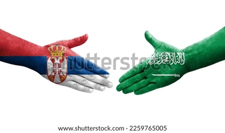 Handshake between Saudi Arabia and Serbia flags painted on hands, isolated transparent image.