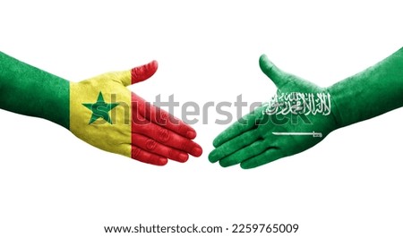 Handshake between Saudi Arabia and Senegal flags painted on hands, isolated transparent image.