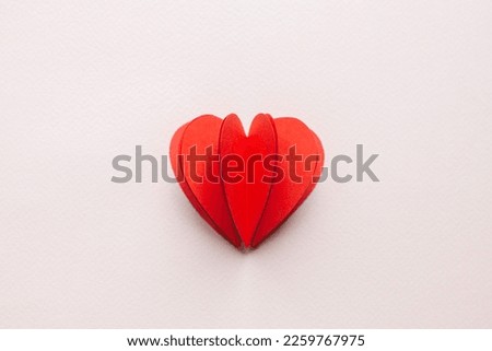 Handmade paper cutout heart for valentine's day on pink background for your offer. 