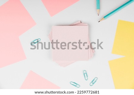 Notebook and Colored Papers Stickers Lying On White Desk. Multiple Assorted Collection Office Stationery. Photo With Pens Pencils Rullers Calculators.