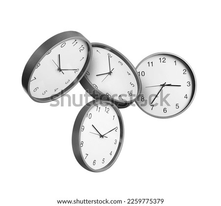 Many stylish clocks falling on white background