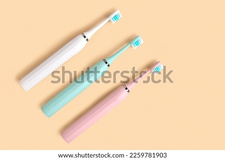 Electric Toothbrush. Top View, Flat Lay, Copy Space. Dental Care Supplies on Beige Pastel Studio Background. Oral Hygiene, Gum Health, Healthy Teeth. Modern Dental Ultrasonic Vibration Tooth Brush Set