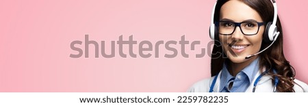 Medic Help Call Center. Face portrait image of smiling doctor in headset. Woman in eye wear glasses spectacles, isolate on rose pink background. Video zoom conference health care advise answering