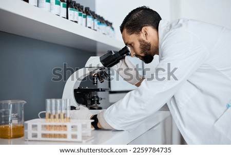 Science, microscope and innovation with a doctor man at work in a laboratory for research or development. Medical, analytics and biotechnology with a male scientist working in a lab for breakthrough