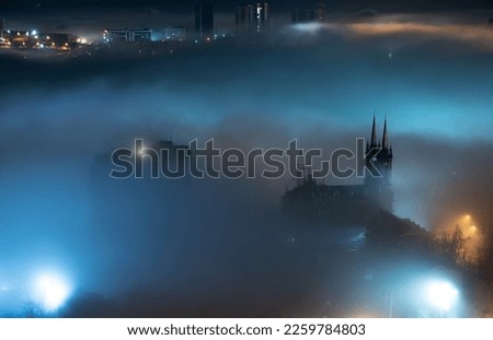 Cityscape night view. Fog over the city.