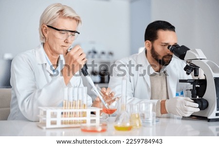 Science, collaboration and research with a medicine team working in a laboratory for innovation or development. Doctor, teamwork or medical with a man and woman scientist at work in a pathology lab Royalty-Free Stock Photo #2259784943