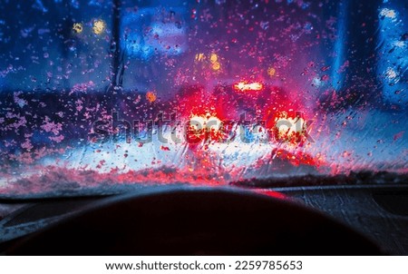 Wet and snowy winter seen through the windshield of a car