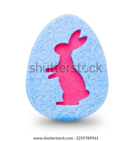 decorative blue easter egg made of felt with the silhouette of an Easter pink bunny. High quality photo