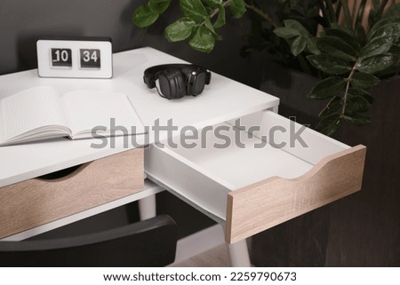 Stylish desk with open empty drawer in office Royalty-Free Stock Photo #2259790673