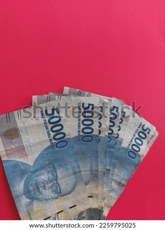 Indonesian Rupiah. 50000 banknote collection on red background