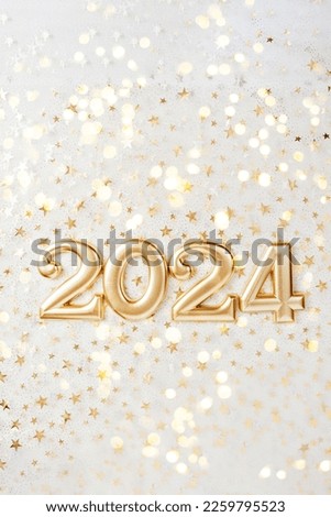 Holiday background Happy New Year 2024. Numbers of year 2024 made by gold candles on bokeh festive sparkling background. celebrating New Year holiday, close-up. Space for text