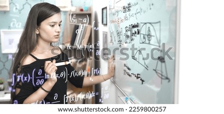 Indian teen student worried write formula think of sums, look on white board with marker pen at educational institute. Schoolgirl face problem while solving mathematics addition questions in classroom Royalty-Free Stock Photo #2259800257