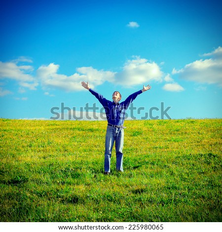Toned photo of Happy Teenager raising the Hands in the Field
