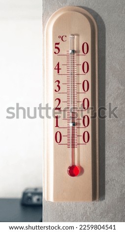 Vertical picture. Mercury room thermometer. The concept of heat at home. Close-up on the thermometer +20 room temperature indicator.