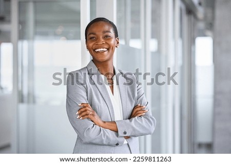 Portrait of successful mature black businesswoman standing in office with copy space. African american business woman in formal clothing standing in modern office: vision and future business company. Royalty-Free Stock Photo #2259811263