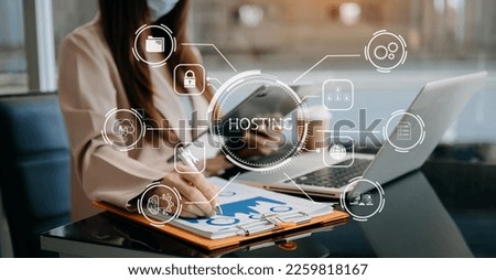 Web hosting concept, woman using computer laptop, tablet and presses his finger on the virtual screen inscription Hosting on desk, Internet, business, digital technology concept.

