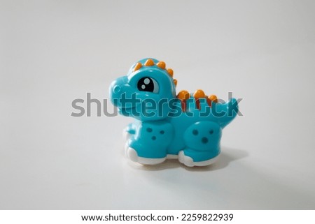 Children's plastic toy. Blue dinosaur on a white background