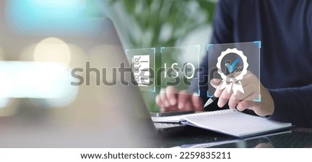 Certification and standardization process, iso certified business, conformity to international standards and quality assurance concept. Person touching certificate icon. Royalty-Free Stock Photo #2259835211