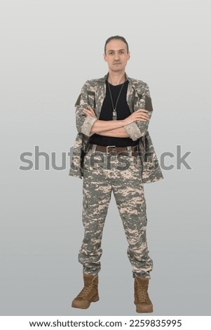Young soldier man isolated on white background looking to the side and smiling