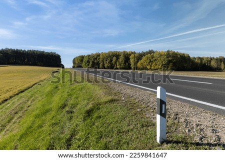 A straight highway without cars, a summer landscape with an empty highway without transport on it