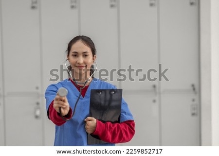 portrait of Cheerful Indian beautiful Asian female doctor posing and smiling at camera, healthcare and medicine
