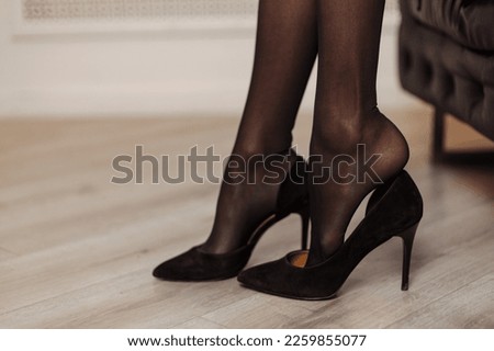 Close up tired young business woman secretary  legs take off shoes heel after work