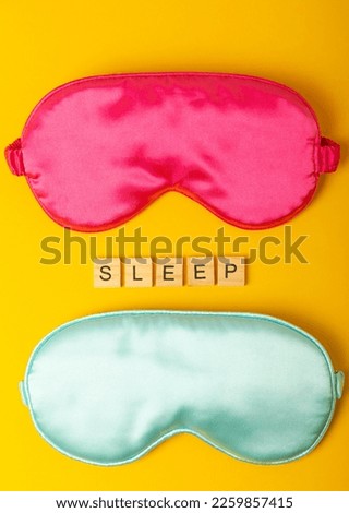 Sleep mask on a yellow background. Sweet dreams concept. The concept of rest, sleep quality, good night, insomnia and relaxation. Flat lay, mockup. view from above