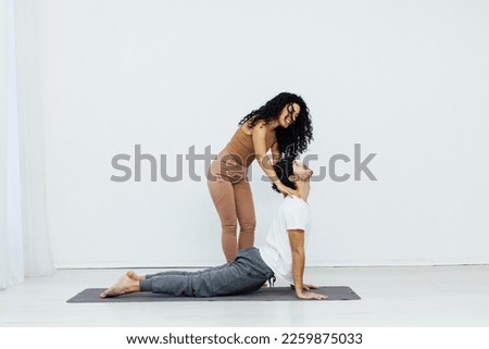 trainer shows yoga stretching classes body work acrobatic exercises for health
