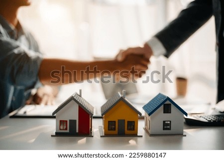  Signing a contract. Client and broker agent, lease agreement, successful deal and  Young business sitting at the desk  Royalty-Free Stock Photo #2259880147