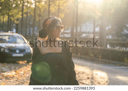 Female tourist enjoy walking through the streets of an European city at sunset with backlight