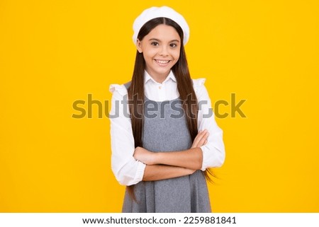 Happy face, positive and smiling emotions of teenager girl. Teenager girl crossed arms isolated on yellow background. Studio portrait of child with mock up copy space.