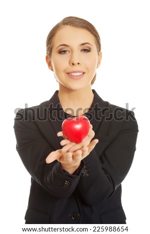 Young beautiful businesswoman holding heart
