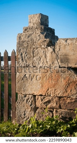 "Year 1951" carved in stone wall in rural fence