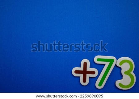 The colorful text +73 is placed at the bottom right of the blue background.