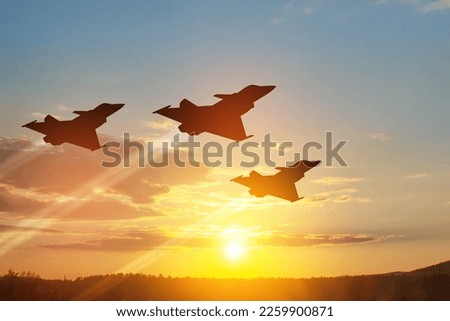 Air Force Day. Aircraft silhouettes on background of sunset or sunrise. Royalty-Free Stock Photo #2259900871