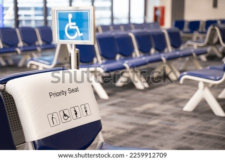 Close-up of a chair in an airport seat, a passenger's special seat. Empty metal chair in the airport waiting room furniture pictures Airport departure or arrival concept image.