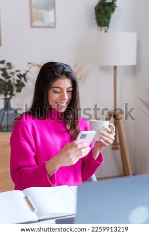 woman using smartphone at home