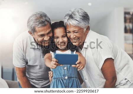 Love, happy and girl taking selfie with her grandparents in the lounge of modern family home. Happiness, smile and excited child taking picture with grandmother and grandfather at a house in Mexico.