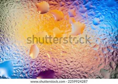 Abstract background. Abstract blur image of colored soft spots and gradients through wet glass. Texture of water drops on glass. Creative background. Horizontal layout