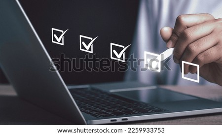 Digital work checklist or electronic smart daily checklist concept. Check mark on virtual screen display for personal working in office Document Management System and process automation. Royalty-Free Stock Photo #2259933753