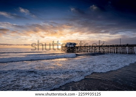 A drone shot of a metallic pier of the sea at sunset, cool for background