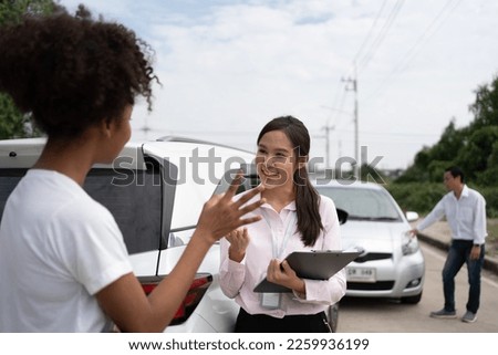 Women drivers Talk to Insurance Agent for examining damaged car and customer checks on the report claim form after an accident. Concept of insurance, advice auto repair shop and car traffic accidents. Royalty-Free Stock Photo #2259936199