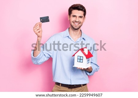 Photo of successful man realtor advise easy payment paypass buy new flat enjoy purchase isolated on pink color background